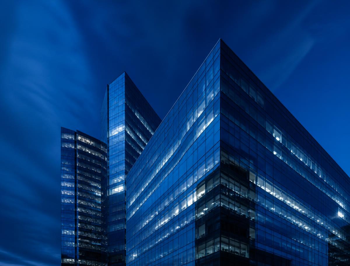 Modern financial district office towers at blue hour